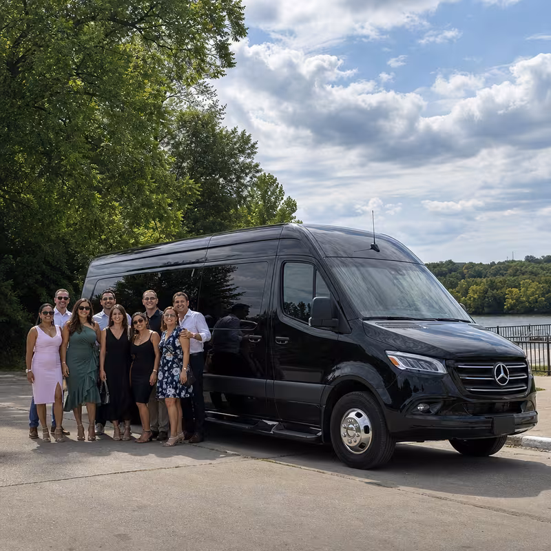 Group beside a Mercedes Sprinter limo from the Des Moines fleet