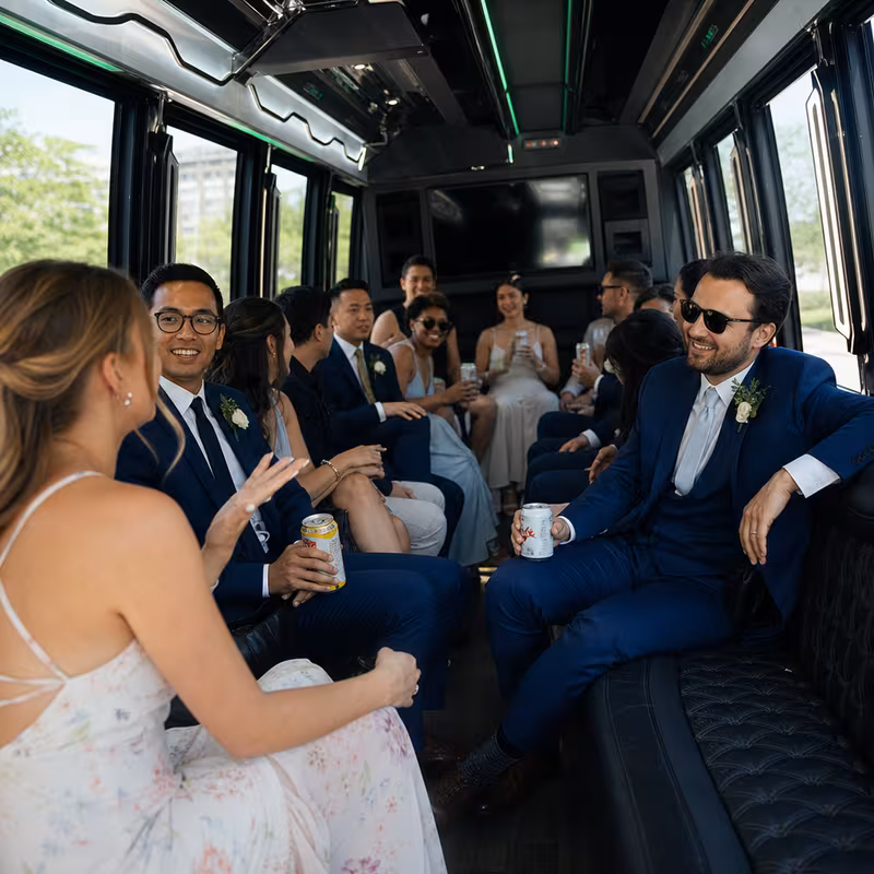 Wedding guests seated inside a Des Moines party bus