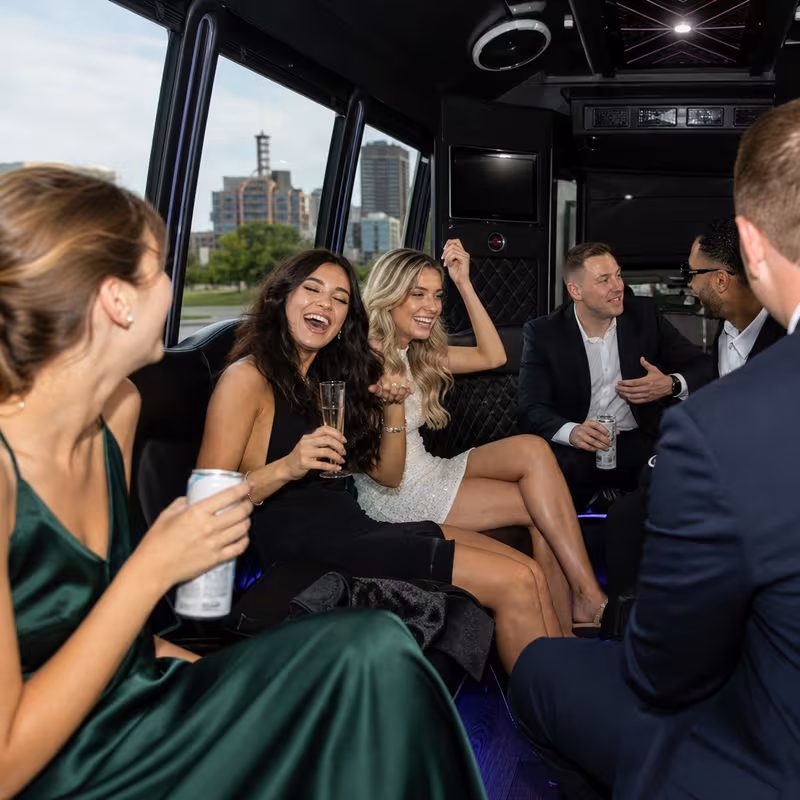 Party bus interior with wraparound leather seating and LED lighting in Des Moines
