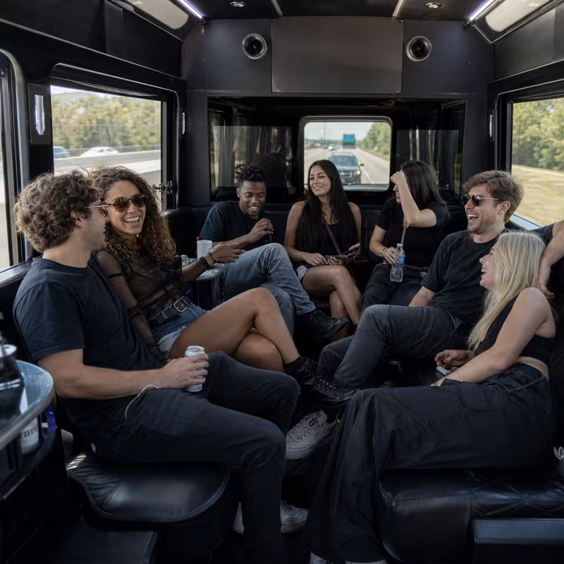 Group boarding a white charter bus for Concert Transportation transportation in Des Moines