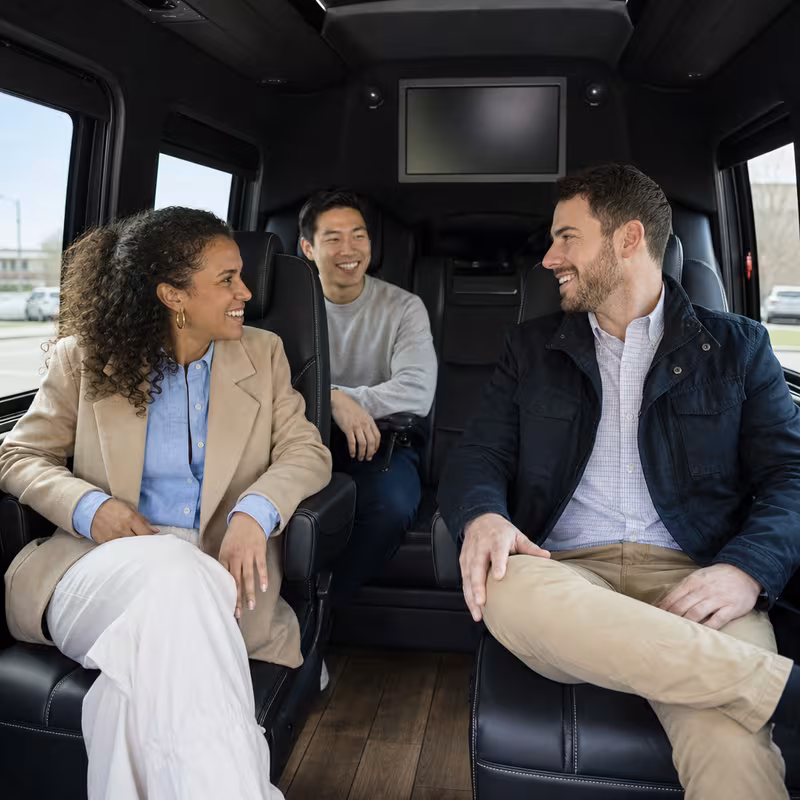 Group boarding a white charter bus for Corporate Transportation transportation in Des Moines