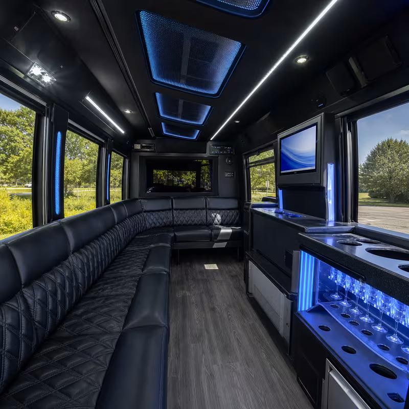 Party bus interior with wraparound leather seating and LED lighting in Des Moines