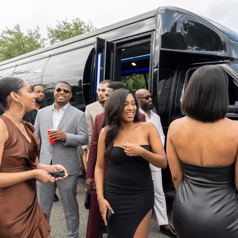 Passengers loading luggage while boarding an Des Moines group shuttle
