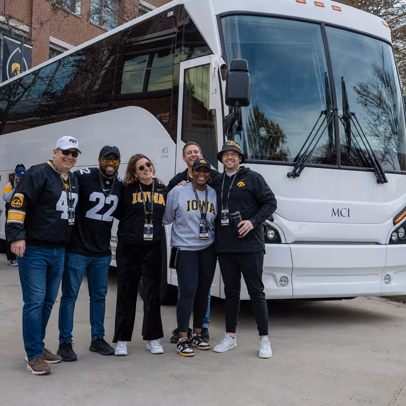 Passengers loading luggage while boarding an Des Moines group shuttle