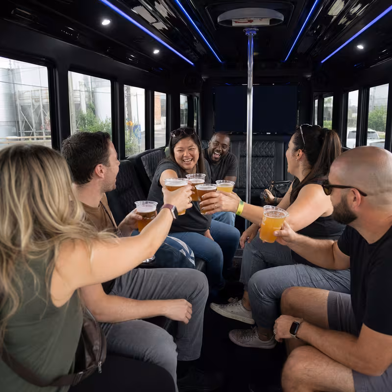 Group boarding a white charter bus for Winery & Brewery Tour Transportation transportation in Des Moines